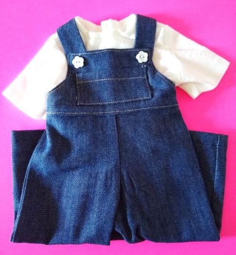 Handmade denim overalls and white T-shirt set for 18-inch dolls, displayed on a bright pink backgrou