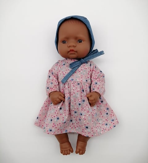 Small Miniland doll in handmade pink dress and denim bonnet