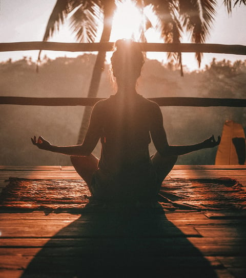 a person sitting in a yoga pose