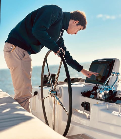 One of our skippers at the helm of our Lagoon 46