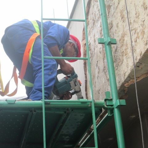 Mechanical stripping of compromised exterior plaster for waterproofing works, Sandhurst Towers, Sandton