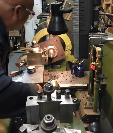 a man in a blue jacket is working on a machine