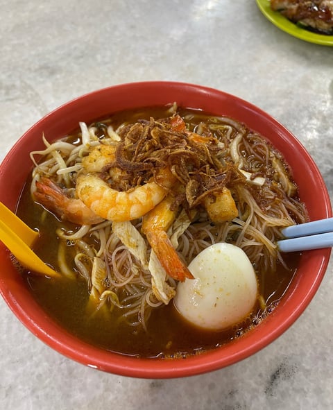 prawn noodles in a flavorful broth with an egg