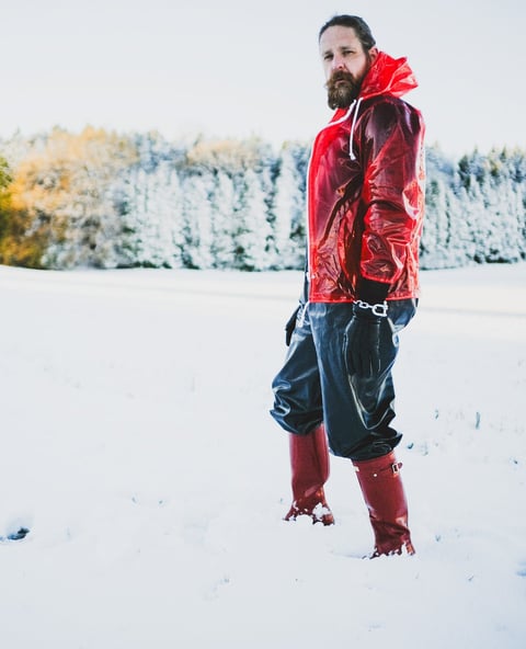 FTSH Studios model (s) Oscar Thickk UK Fetish Model wearing red vinyl jacket, farmerrain body suit, red hunter wellies, snow
