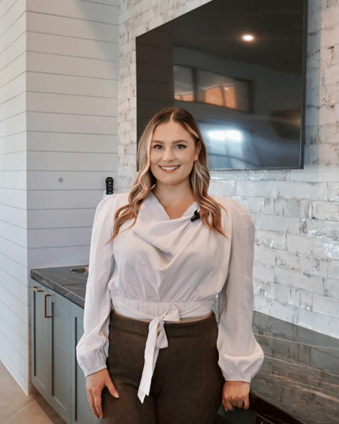 a woman in a white blouse and brown pants Houston Texas Real Estate Agent Stephanie Adams Ask Ozzie 