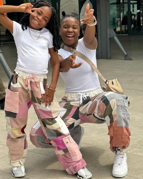 fronita and Abigail in matching clothes at the airport.