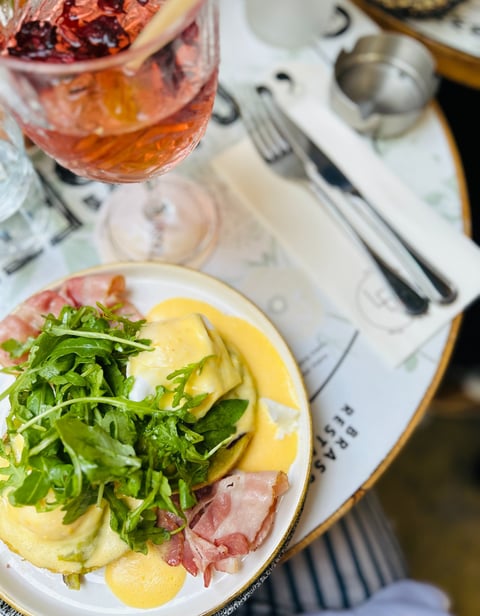a plate of food with a glass of wine and a glass of wine