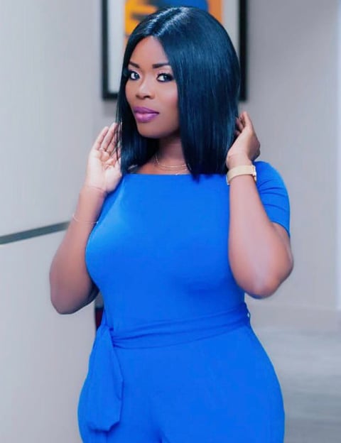 Delay in a blue overall dress.