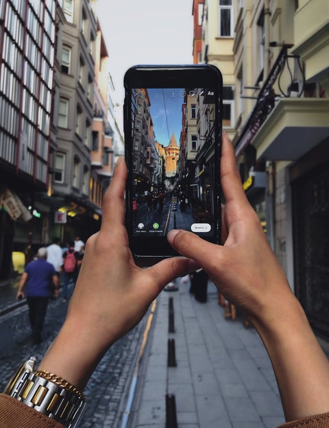 a person holding a cell phone in their hand