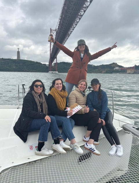 Bachelorette party aboard our Lagoon 46 with a view of the Cristo Rei and the 25th of April Bridge