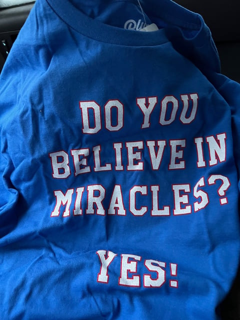 a blue shirt with a message that says do you believe in the middle of the