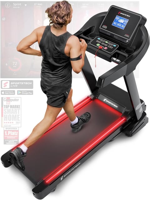 a man running on a treadmill with a red light