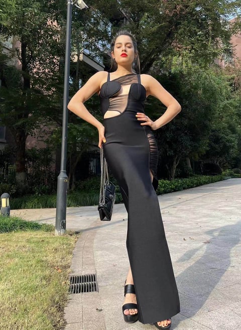 Fashion influencer cynthia Scellos in a black cutout dress from Bella Barnett_ night out dress first