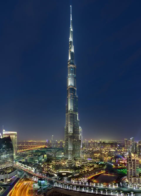 a tall building with a tall tower in the middle of it