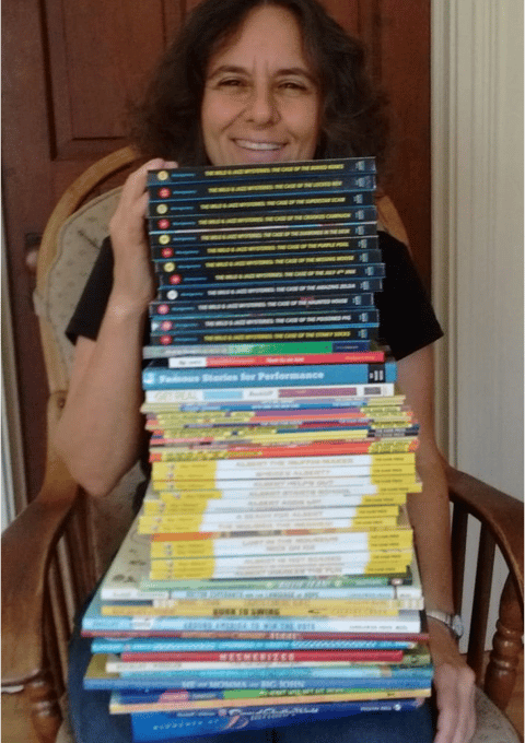 Holding tall stack of my books