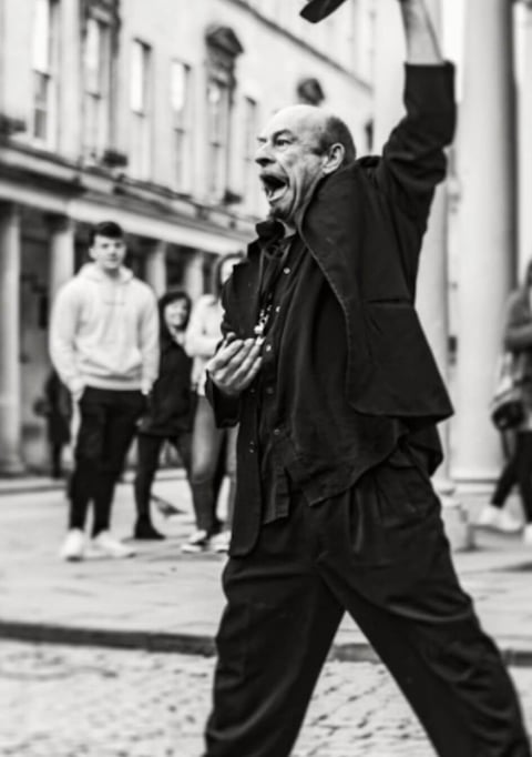 Person talking loud on the street trying to convey a message