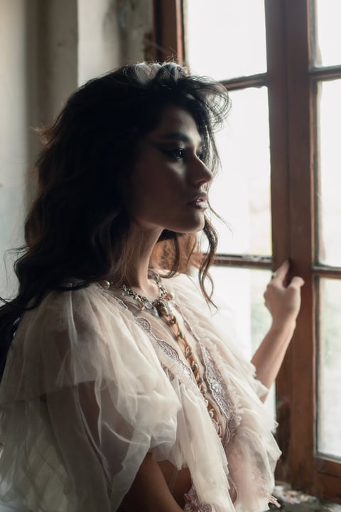 a woman in a white dress and a necklace