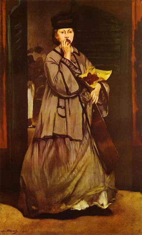 a woman in a long dress and a hat