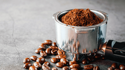 a coffee grinder with coffee beans and coffee beans