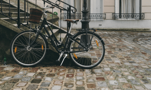 a bicycle parked next to a stair casement