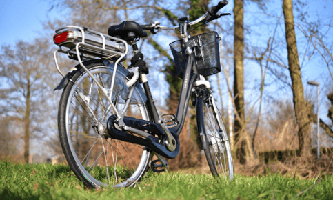 a bicycle parked in a grassy area