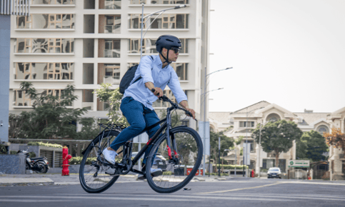 a man riding a bicycle on a city street