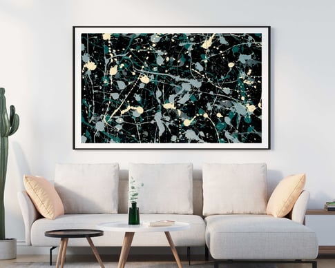 a couch with an splatter abstract painting of a black and white paint