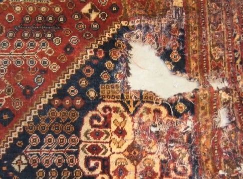 moth holed damaged rug