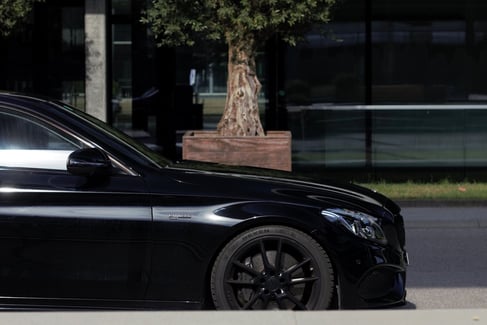 a black car parked on the side of the road