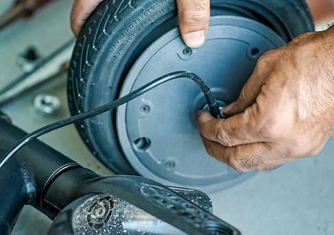 a man is holding a wheelbar while he is working on a wheel