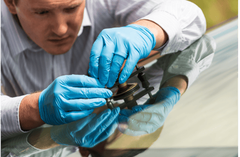 a man in gloves and gloves is holding a pair of scissors