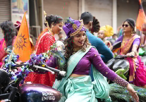 woman in maharastrian traditional outfit riding a motorbike in girgaon gudipadwa shobhayatra 2025