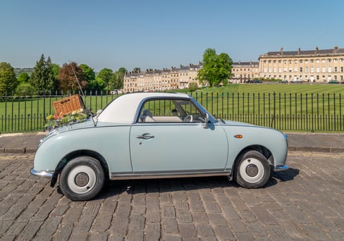 Nissan Figaro classic car with picnic basket near Royal Crescent, Bath