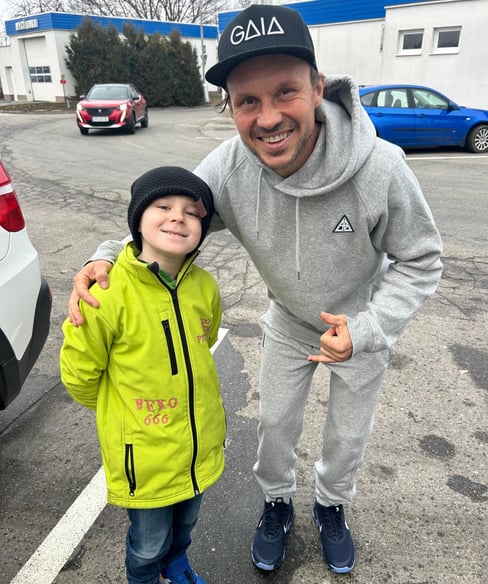 a man and a child standing in a parking lot