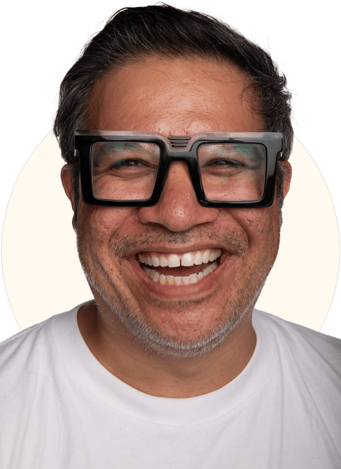 Tio Toto - smiling with black rim glasses and a white shirt