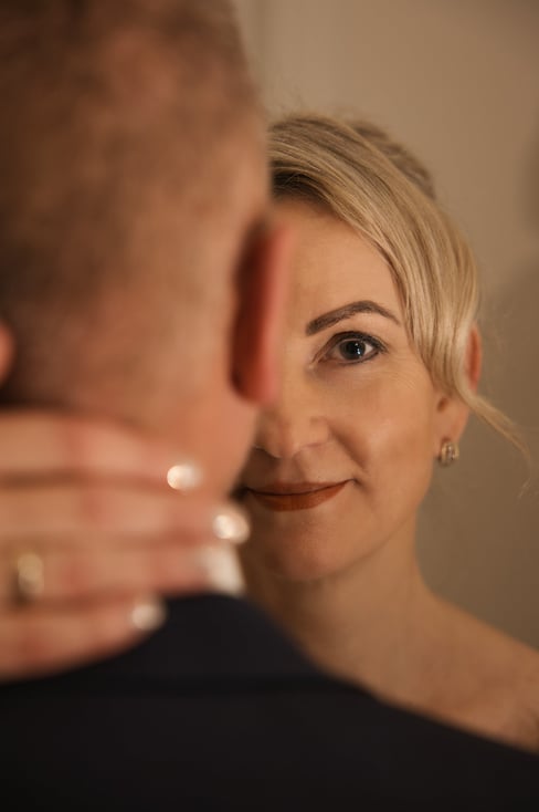 a woman in a wedding dress is looking at the groomsmen