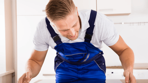 a man in a blue overalls and a white shirt
