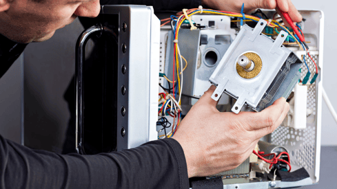 a man is fixing a computer monitor in a computer