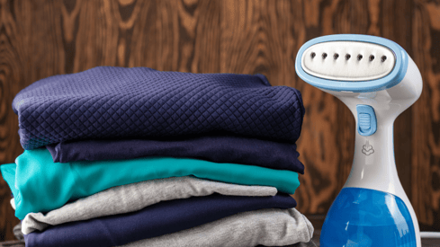 a pile of folded folded towels and a blue and white electric razor razor razor razor