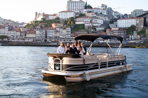 Group enjoying private pontoon boat tour on Douro River in Porto, Portugal
