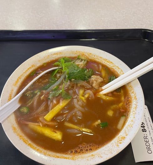 Laksa, a noodle dish in a fish based broth with cucumber and pineapple