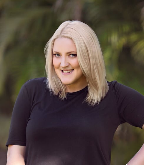 a woman with blonde hair and a black top