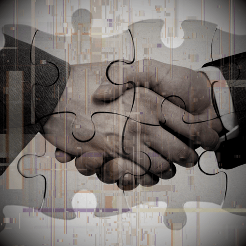 a puzzle piece of puzzle pieces with a handshake