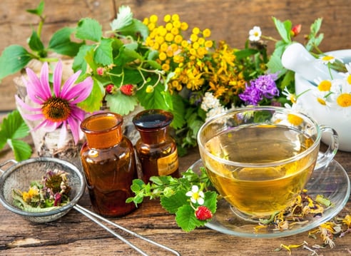 a cup of tea and a teapot with flowers