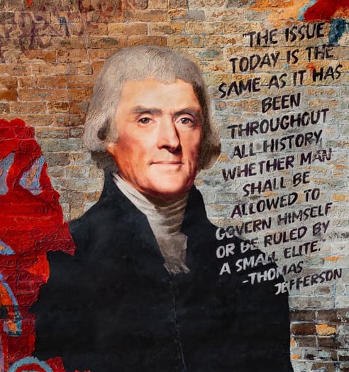 Mixed media portrait of Thomas Jefferson by Martin Osner with his quote on a graffiti brick wall.