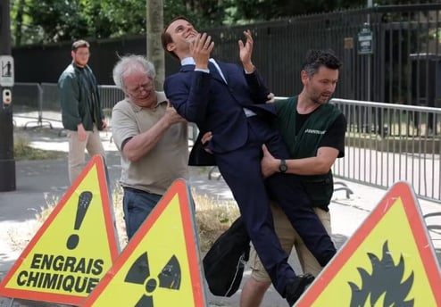 a man in a suit and tie is being carried by a man in a suit