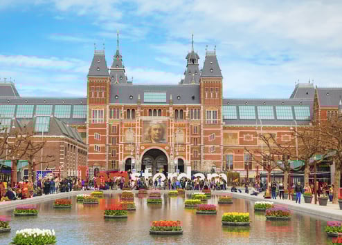 a large building with a fountain in front of a large building