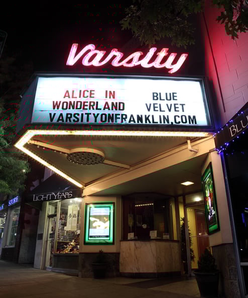 a theater marquee with a sign that says alice in wonderland