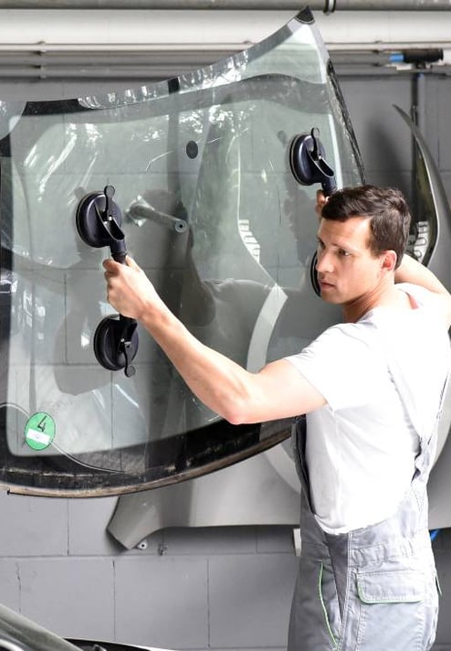 a man in a white shirt is standing in front of a car