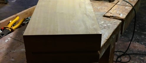a wooden box with a piece of wood on top of a table